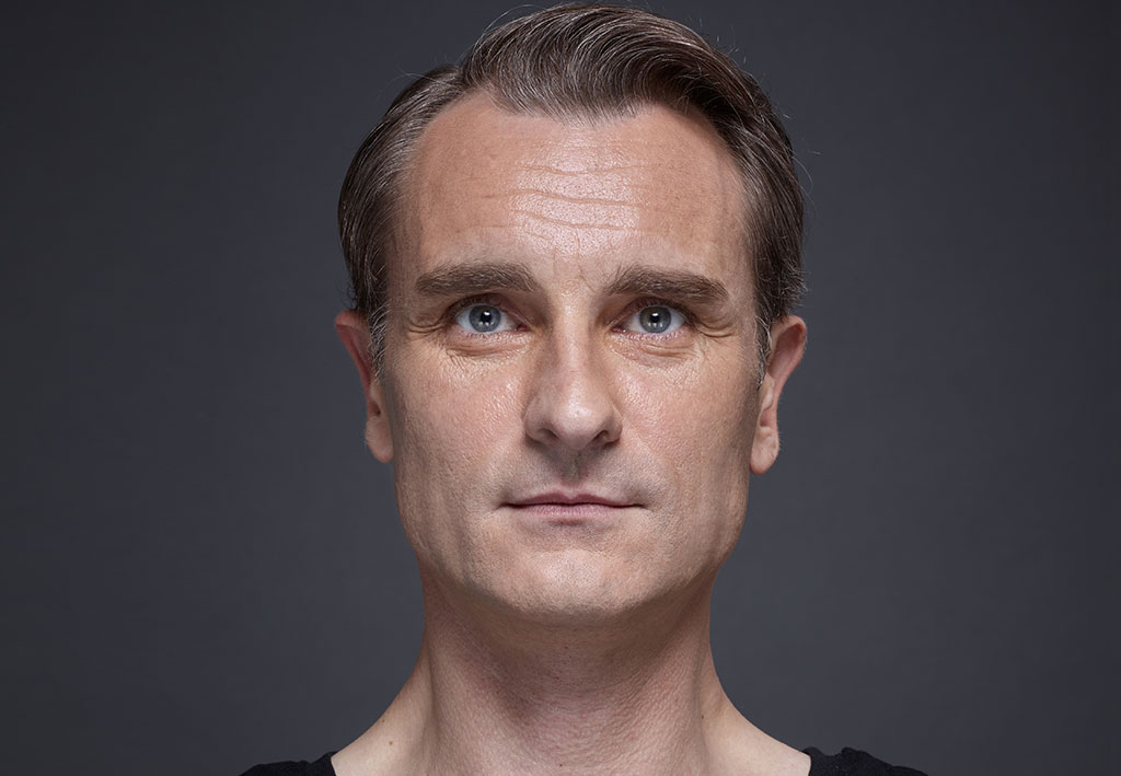 Man face with brown eyes on grey background | Fillmed